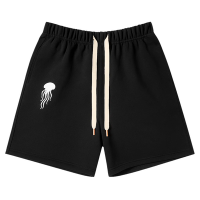 Black shorts with a white jellyfish logo on a light gray background
