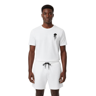 Man wearing a white t-shirt and shorts set with a jellyfish design on a white background