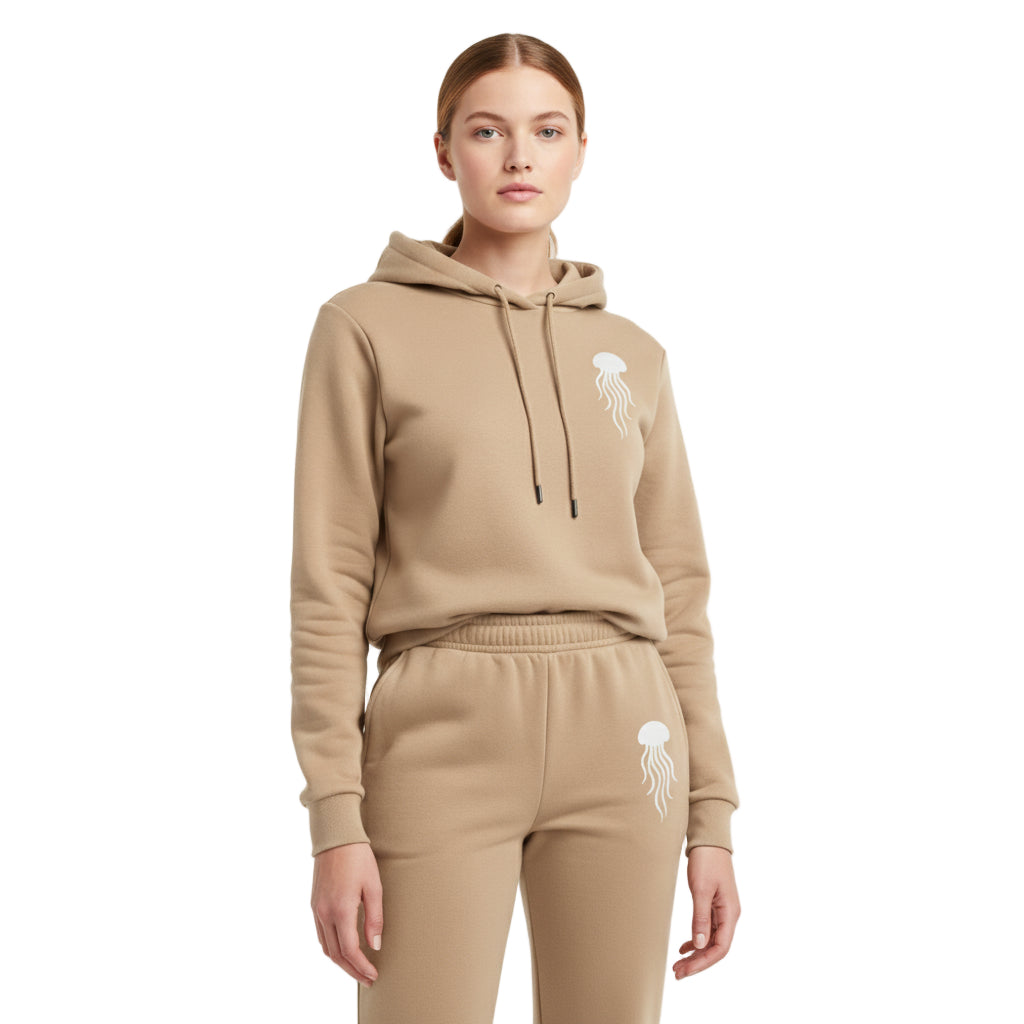 A woman wearing beige hoodie and pants set with a jellyfish design on a white background