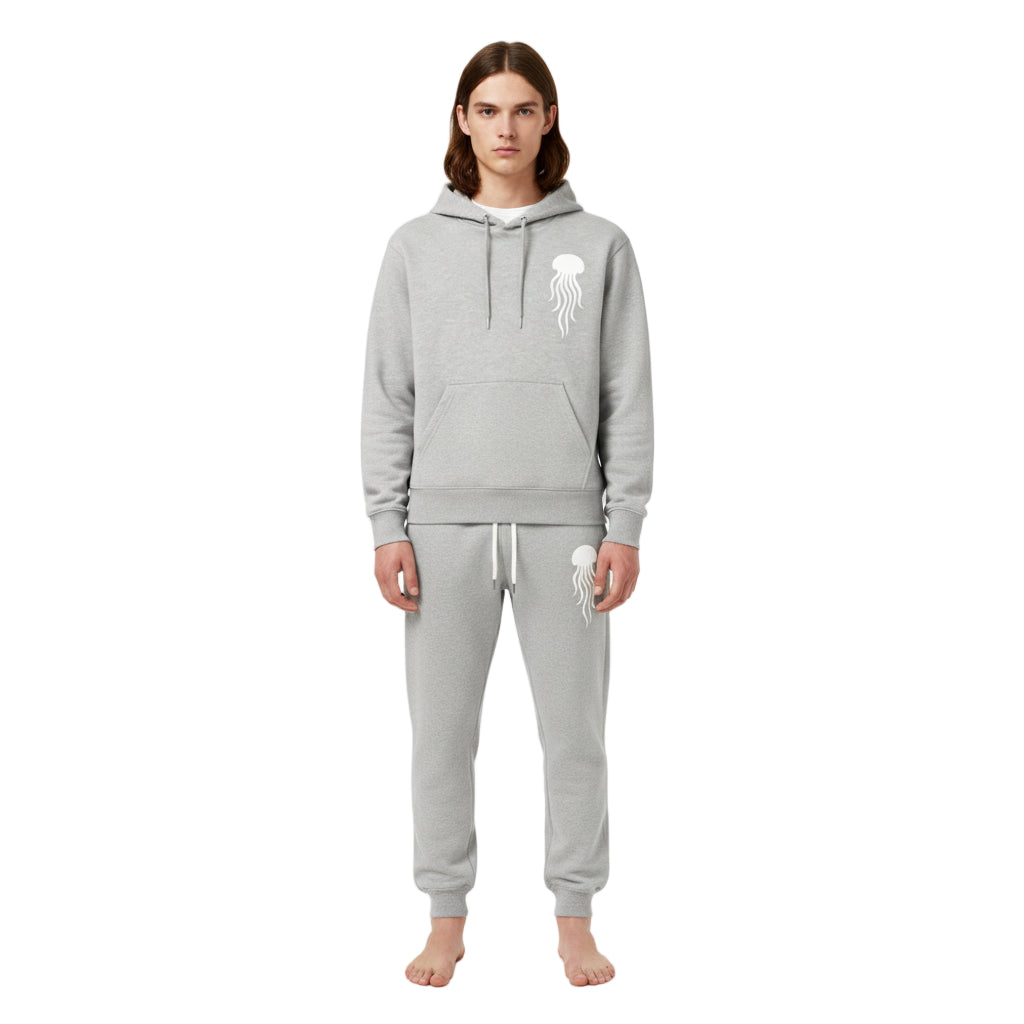 Person wearing a gray hoodie and pants with a logo on a white background