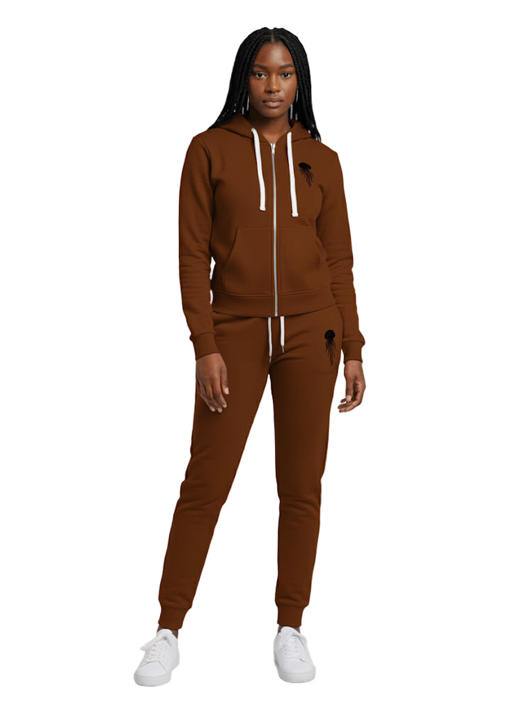 A woman wearing a brown stratosphere zip-up hoodie & jogger set with jellyfish logo color in black