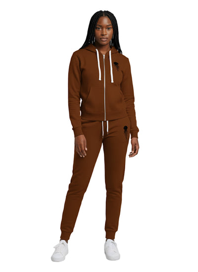 A woman wearing a brown stratosphere zip-up hoodie & jogger set with jellyfish logo color in black