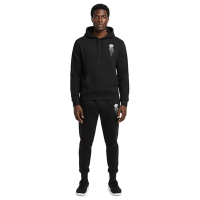 A man wearing a black hoodie and pants with a jellyfish logo on a white background